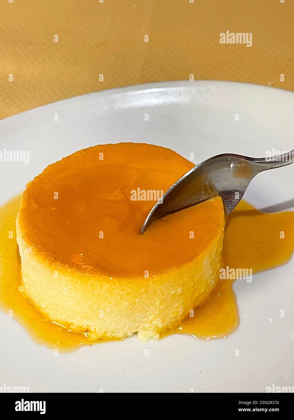 Eating creme caramel. - Smartphone Captured Stock Image