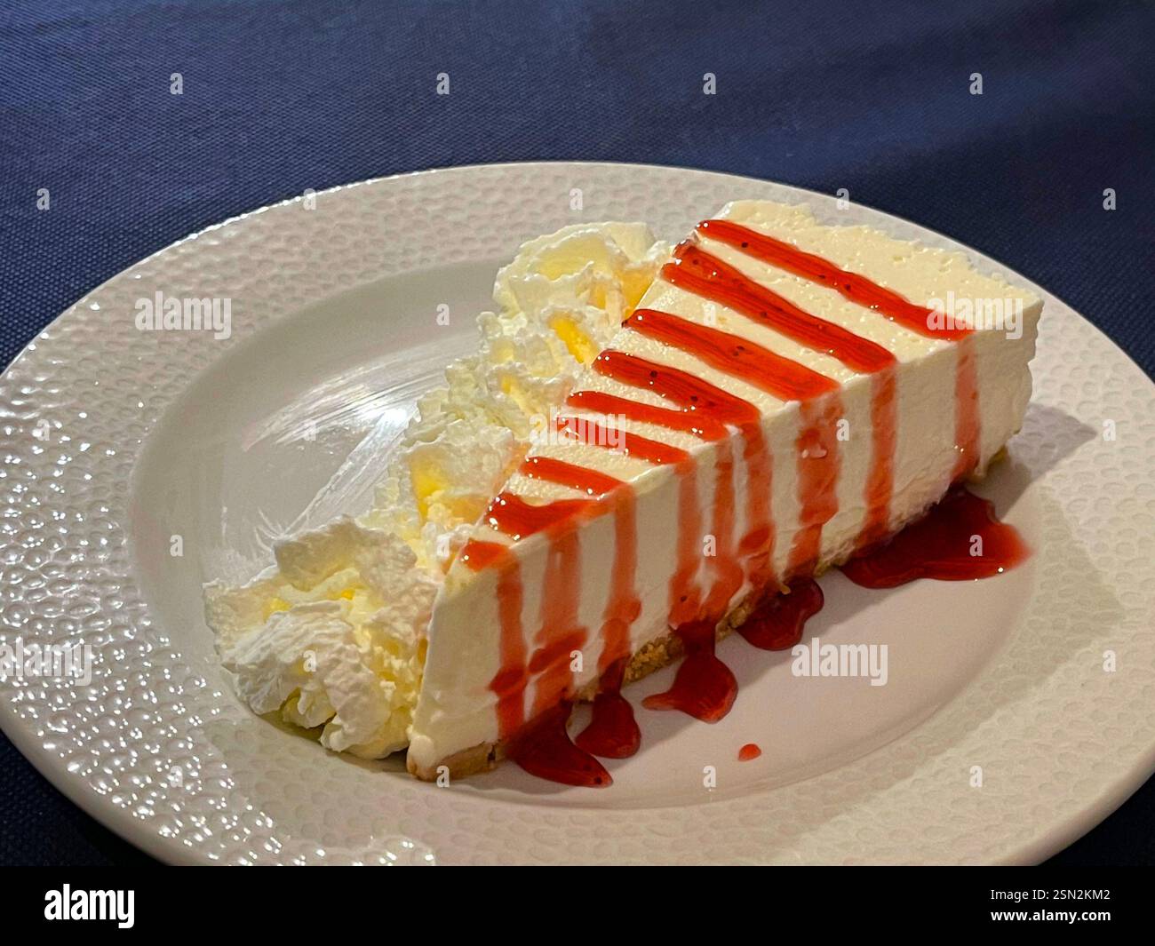 Cheese cake with strawberry syrup. Stock Photo