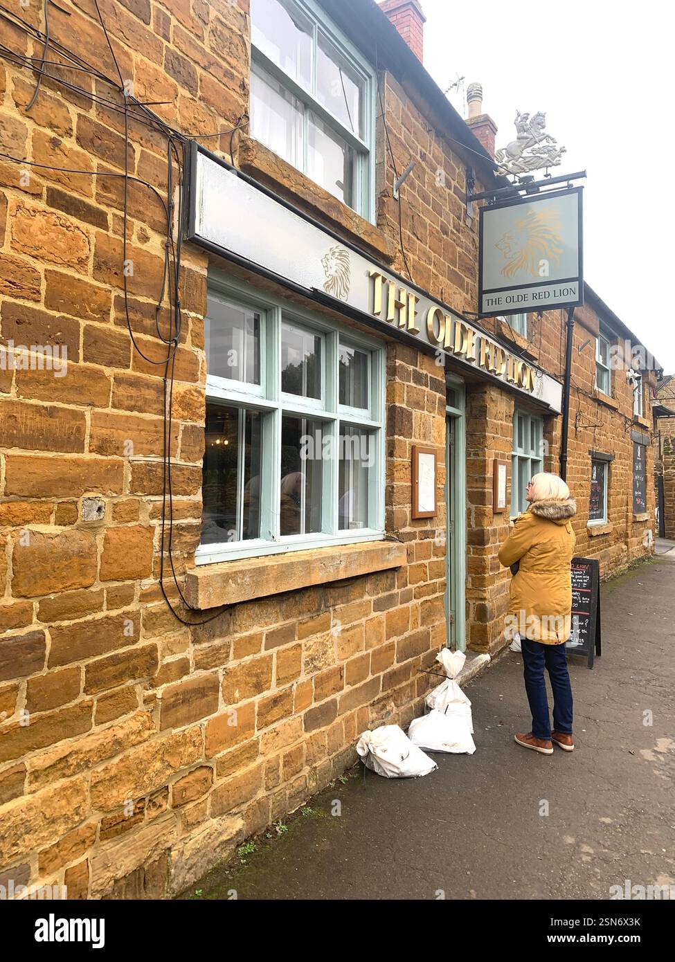 The old Red Lion Kislingbury Northamptonshire Northampton England UK British public house Village life old stone building historic history food eat - Smartphone Captured Stock Image