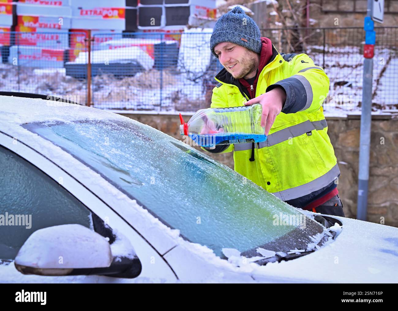 Trest, Czech Republic. 13th Feb, 2025. Driver scraping ice from the car