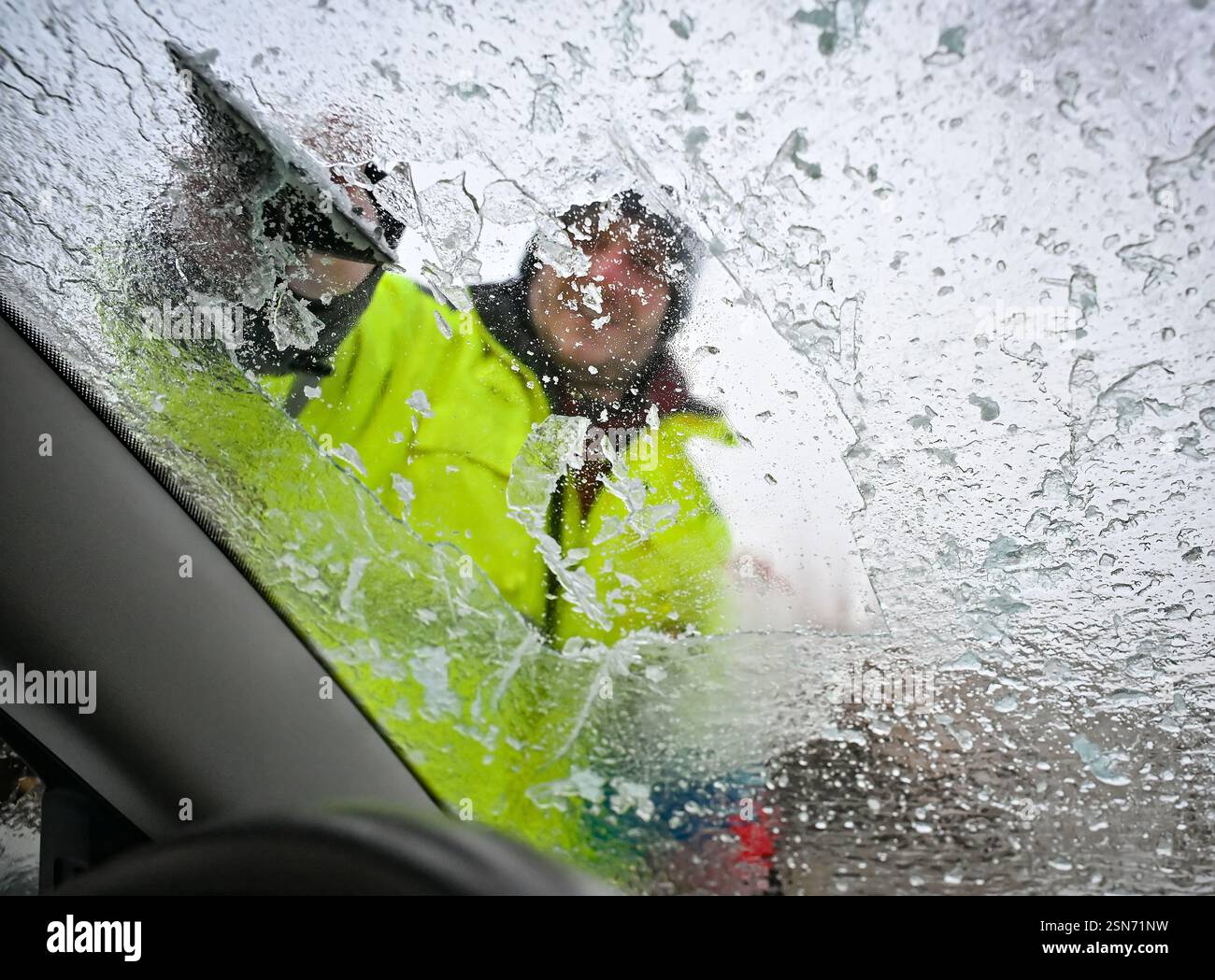 Driver scraping ice from the car window in Trest, Czech Republic