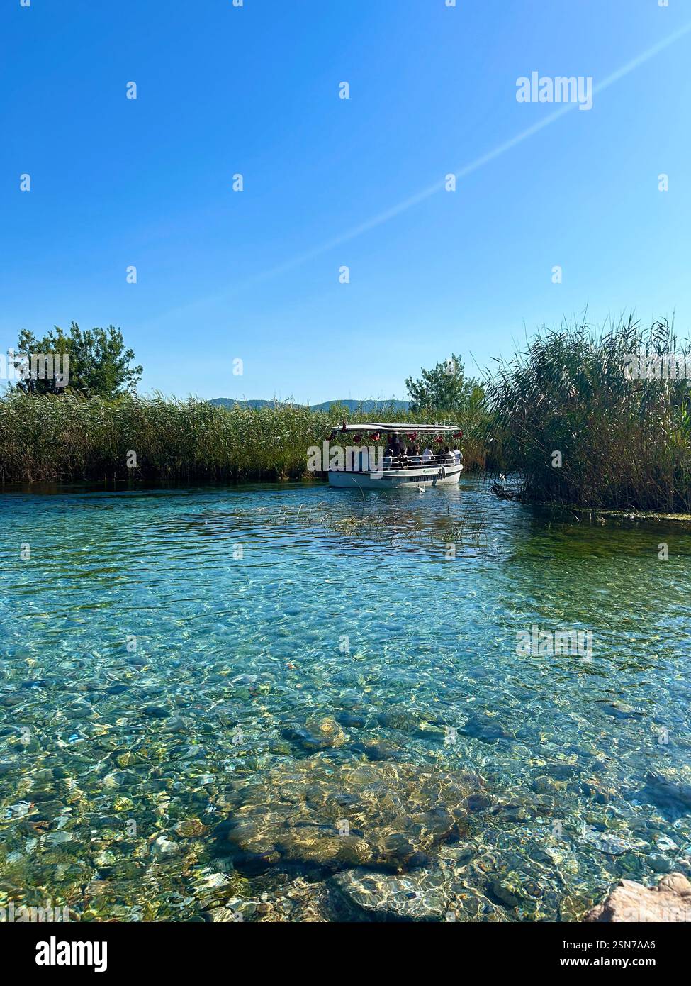 View of the crystal clear blue waters of the Azmak river in Akyaka, Türkiye - Smartphone Captured Stock Image
