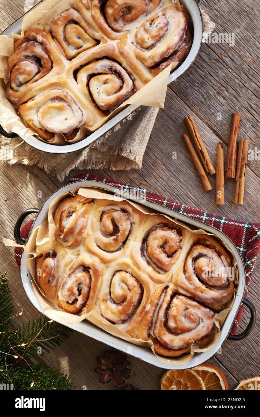 Homemade cinnamon rolls in two baking pans on a table, top view Stock Photo