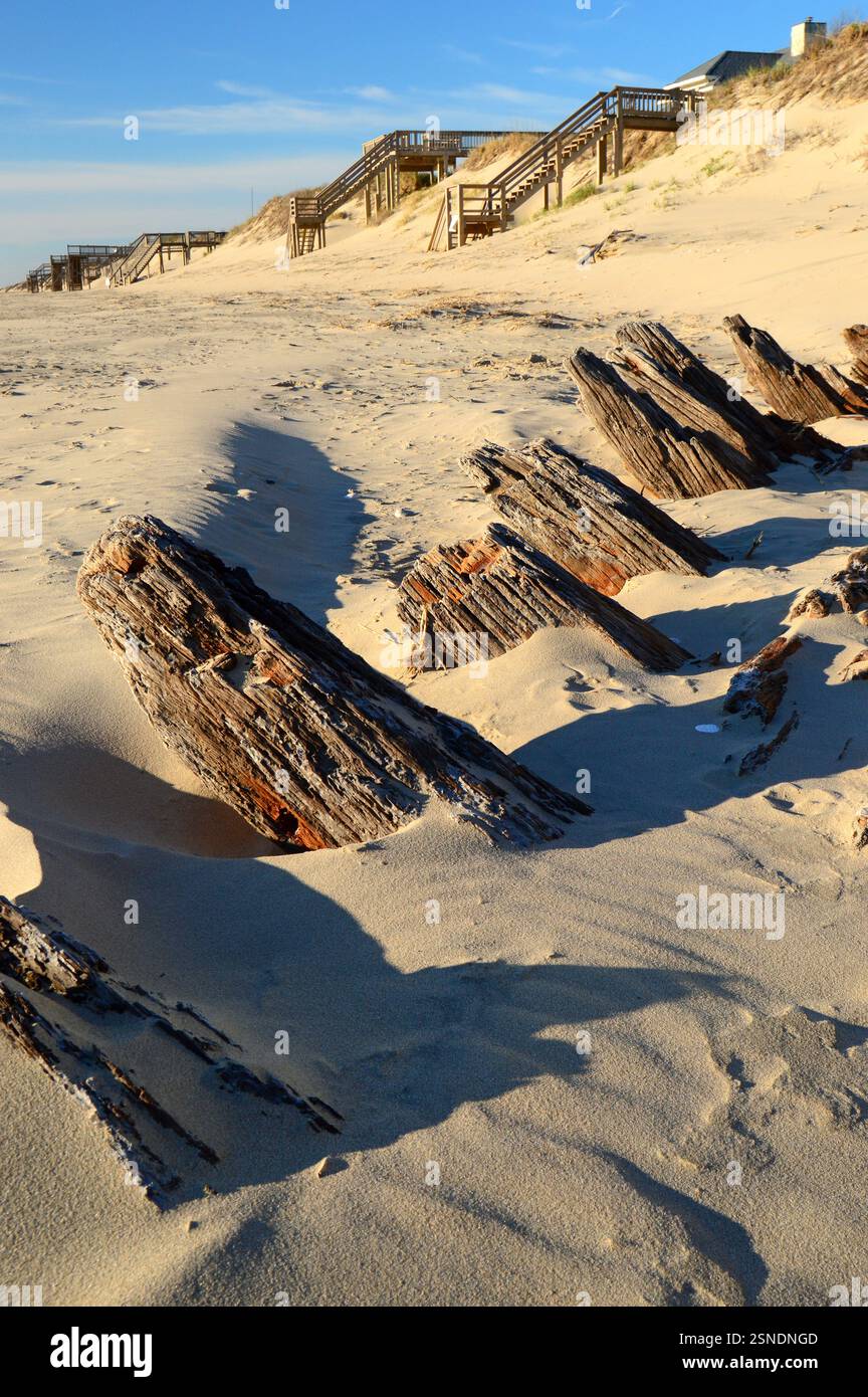 The remains of a 18th Century shipwreck pokes through the sands of a beach in Outer Banks in North Carolina Stock Photo