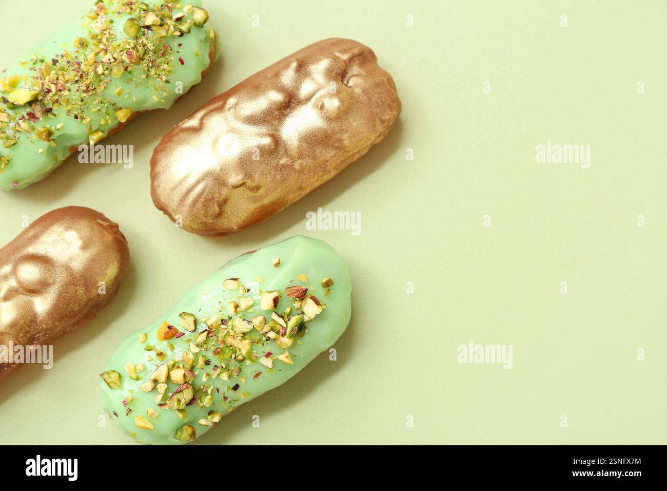 Composition with tasty glazed eclairs on color background Stock Photo