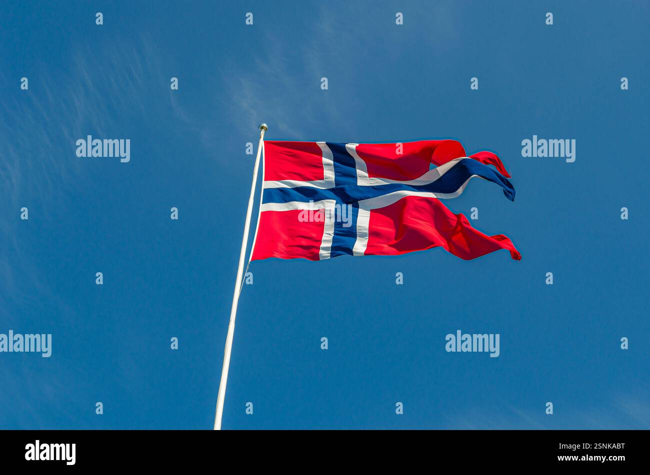 Norway flag waving in the wind on blue sky background Stock Photo - Alamy
