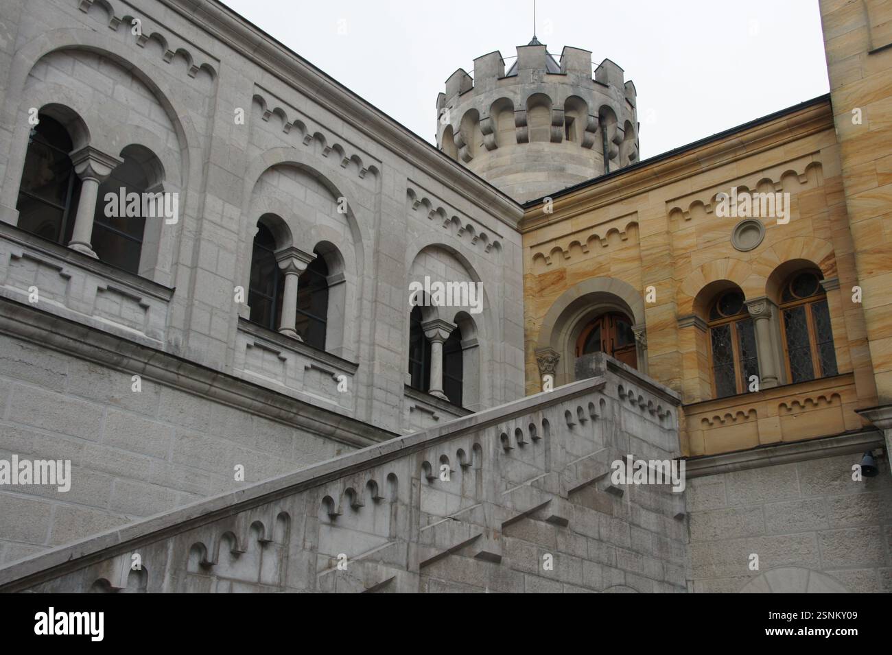 Castle Railing Torret A winding stone staircase with a wrought iron railing spirals around a ...