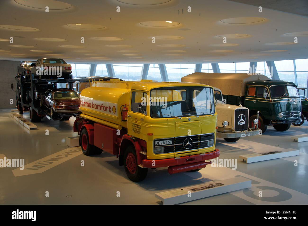 Mercedes-Benz trucks and cars gleam in a vast museum hall, Germany ...