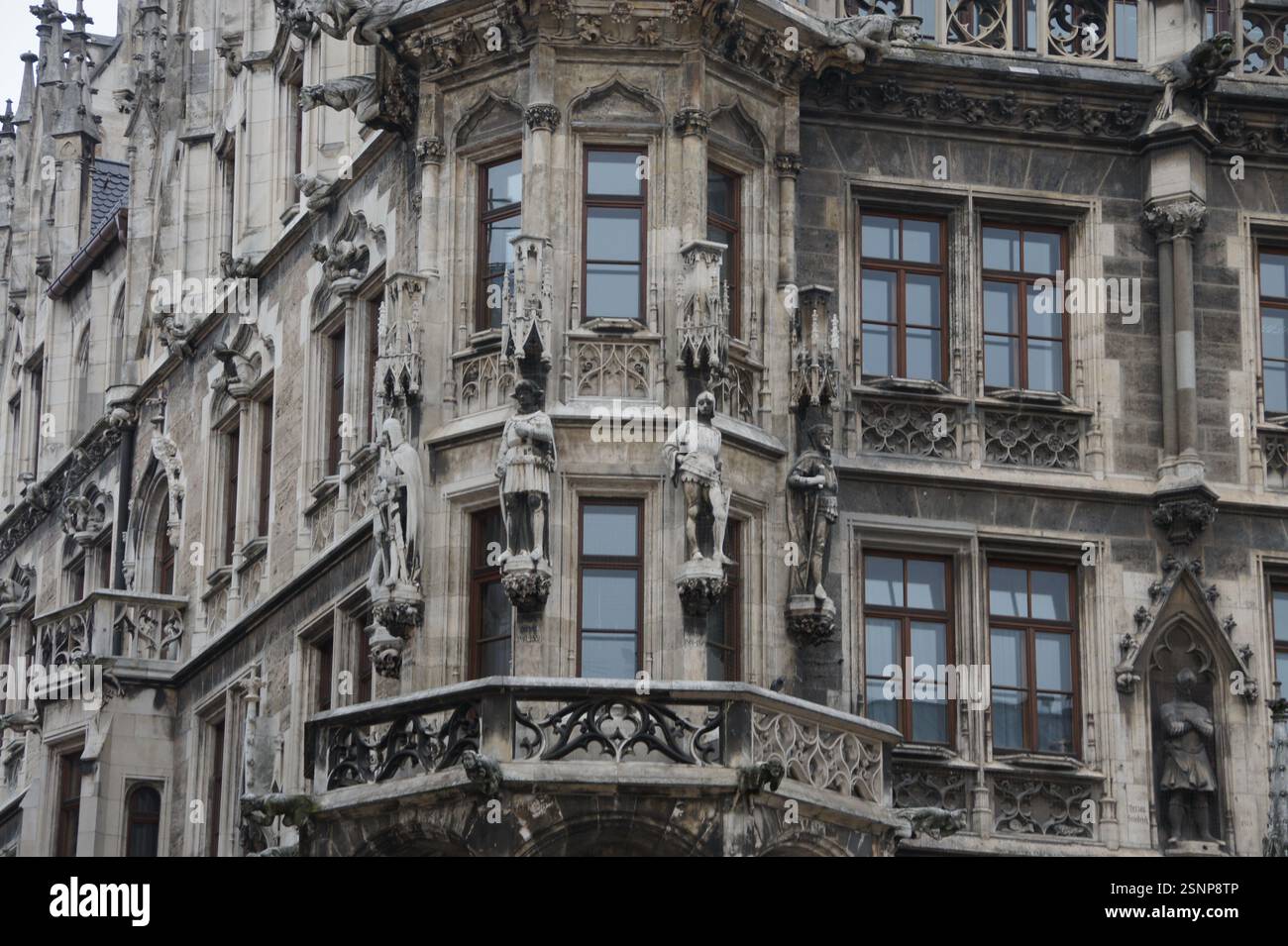 The facade of an ornate Gothic building in Germany, Munich, boasts ...
