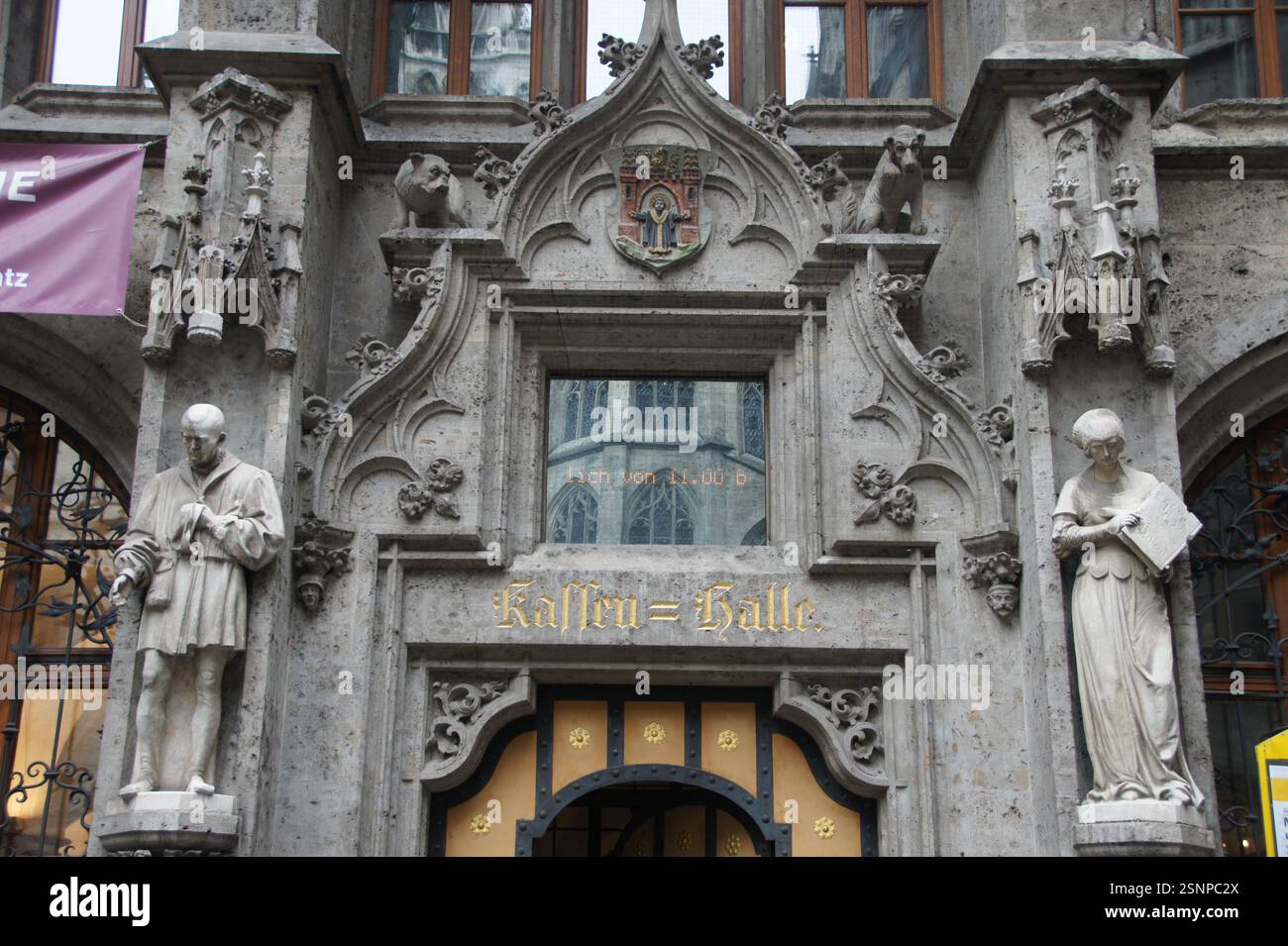 Munich, Germany's Alten Rathaus facade boasts intricate details, statues, and a thought-provoking inscription: "Kaufen = Galle," which translates to " Stock Photo