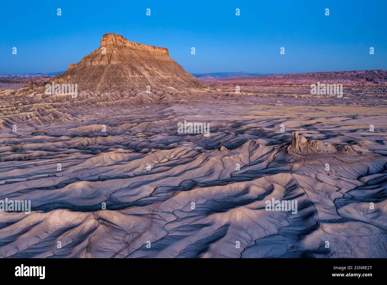 Aerial view of Factory Butte just before sunrise featuring the stunning