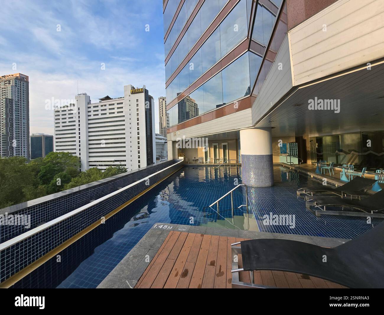 The rooftop swimming pool at the Pullman hotel on Si Lom Road in Bangkok, Thailand. - Smartphone Captured Stock Image