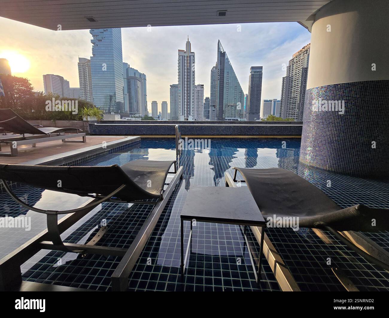 The rooftop swimming pool at the Pullman hotel on Si Lom Road in Bangkok, Thailand. - Smartphone Captured Stock Image
