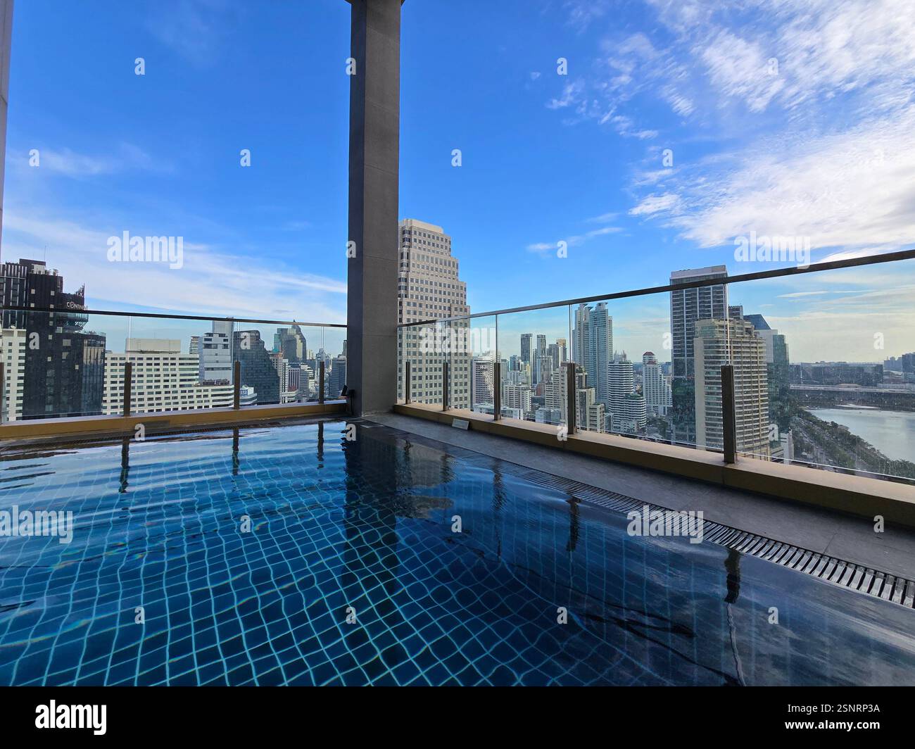 The rooftop swimming pool at the Solaria Nishitetsu hotel on Sukhumvit Road in Bangkok, Thailand. - Smartphone Captured Stock Image