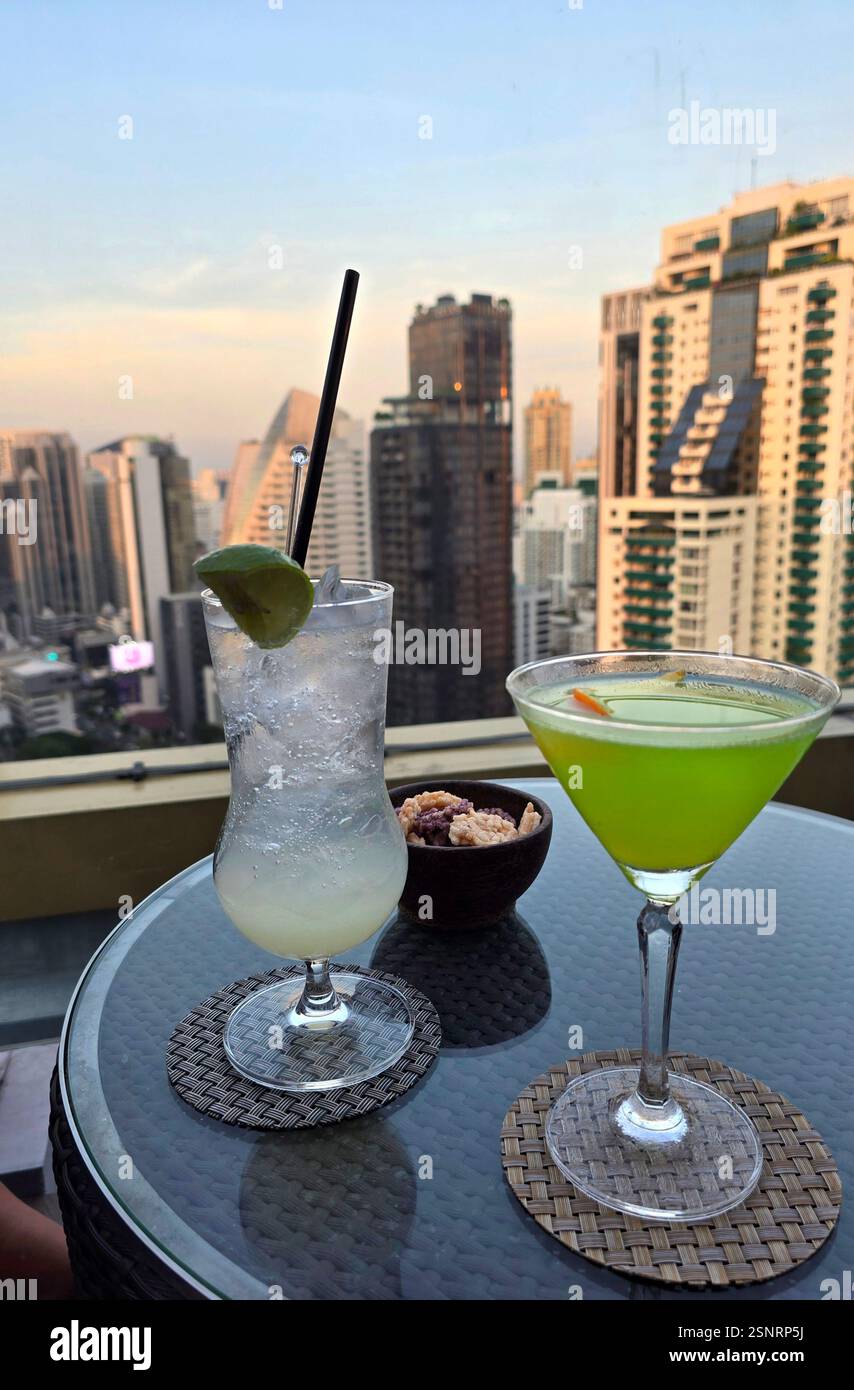 Having cocktails at the beautiful rooftop bar at the Solaria Nishitetsu Hotel on Sukhumvit Road in Bangkok, Thailand. - Smartphone Captured Stock Image