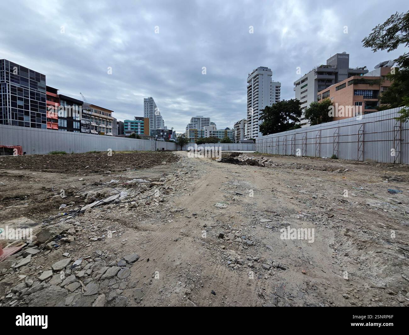 The construction site replacing Chuvit Garden by Soi 10 on Sukhumvit road in Bangkok, Thailand. - Smartphone Captured Stock Image