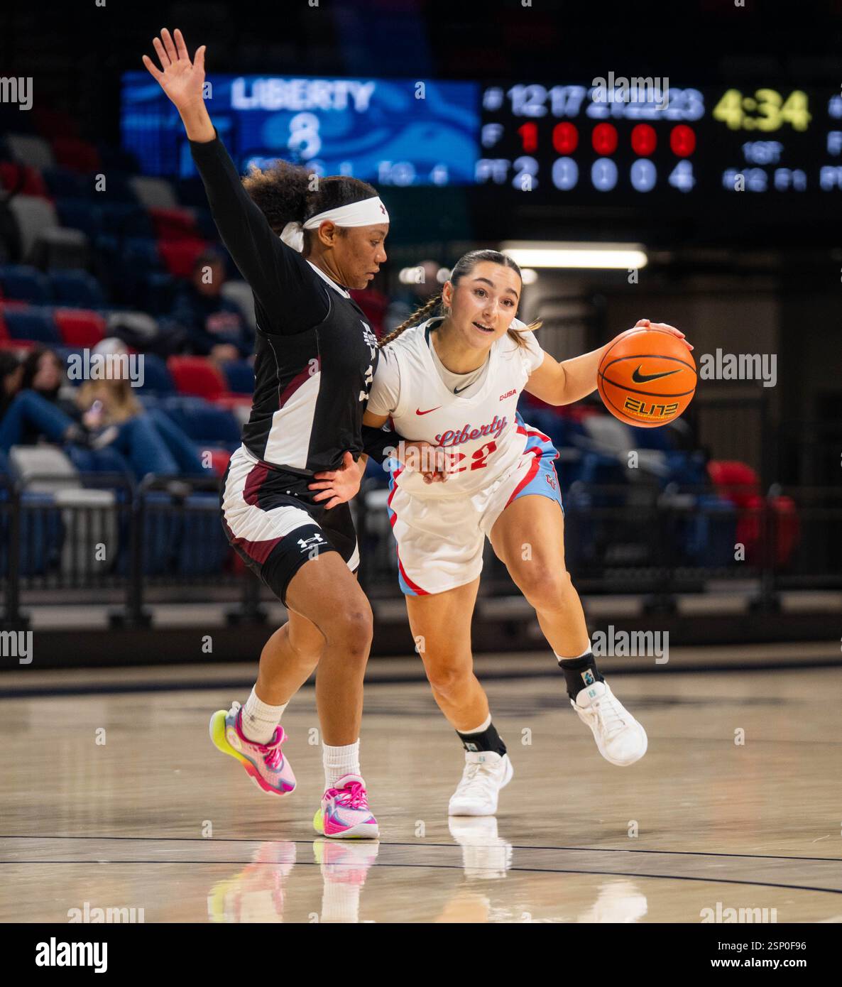 Anna Badosa #22 of the Liberty Lady Flames dribbles by Sianny Sanchez