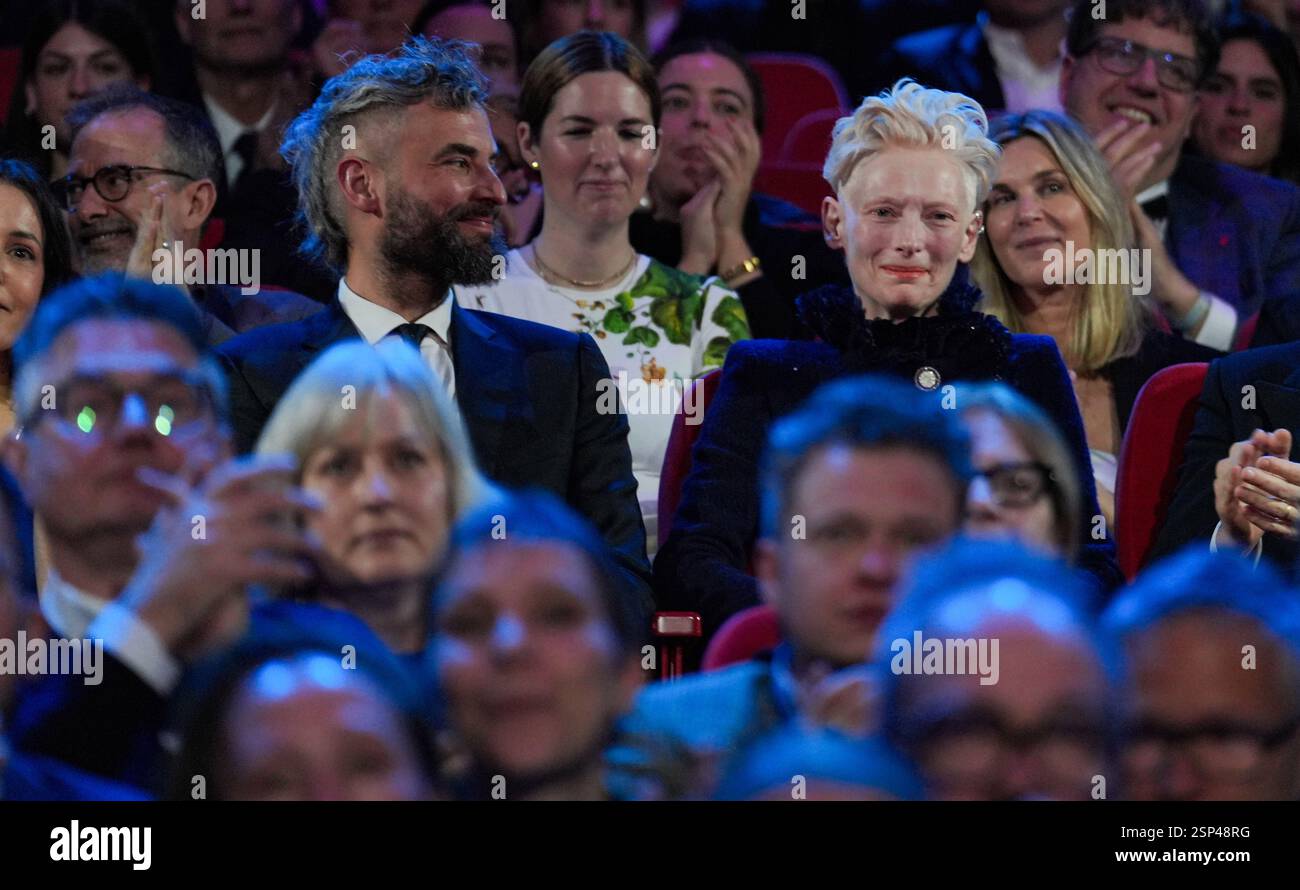13 February 2025, Berlin: Tilda Swinton (r) sits next to her p…