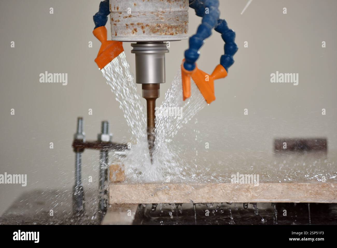 Robot working on milling sculpture in natural stone Stock Photo