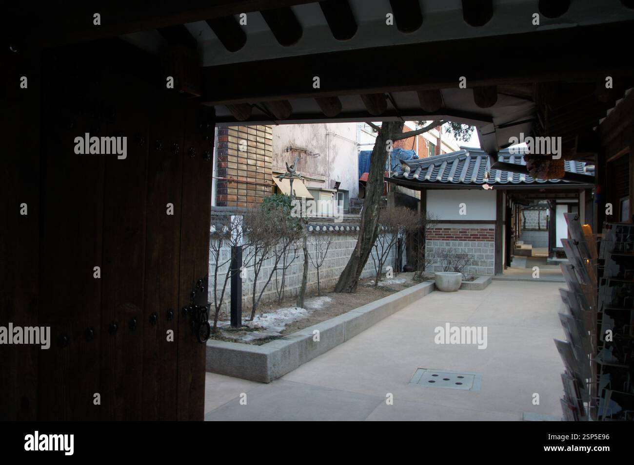 Hanok courtyard, South Korea. Stone wall with tiled roof, South Korea. Tranquil traditional space, South Korea. Korean heritage, South Korea. Quietude Stock Photo