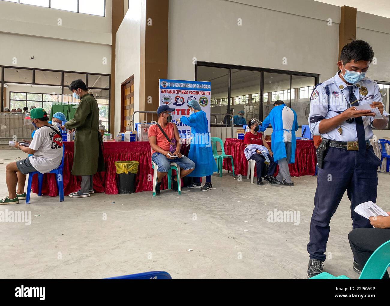 Covid 19 mega vaccination site in a convention center for Filipino National Vaccinations Days, Philippines province, face masks & shields mandatory - Smartphone Captured Stock Image
