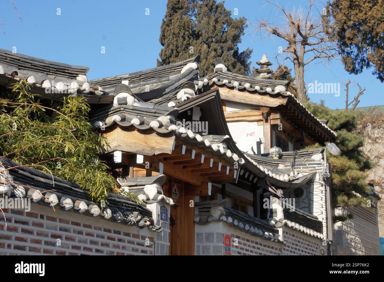 Korean traditional house with tiled roof, wooden beams, and brick wall ...