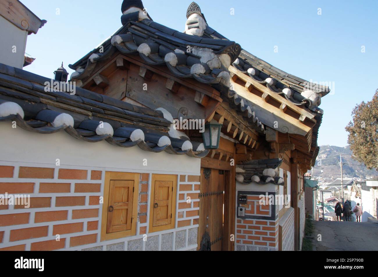 Korean traditional house with tiled roof, white walls, and wooden beams ...