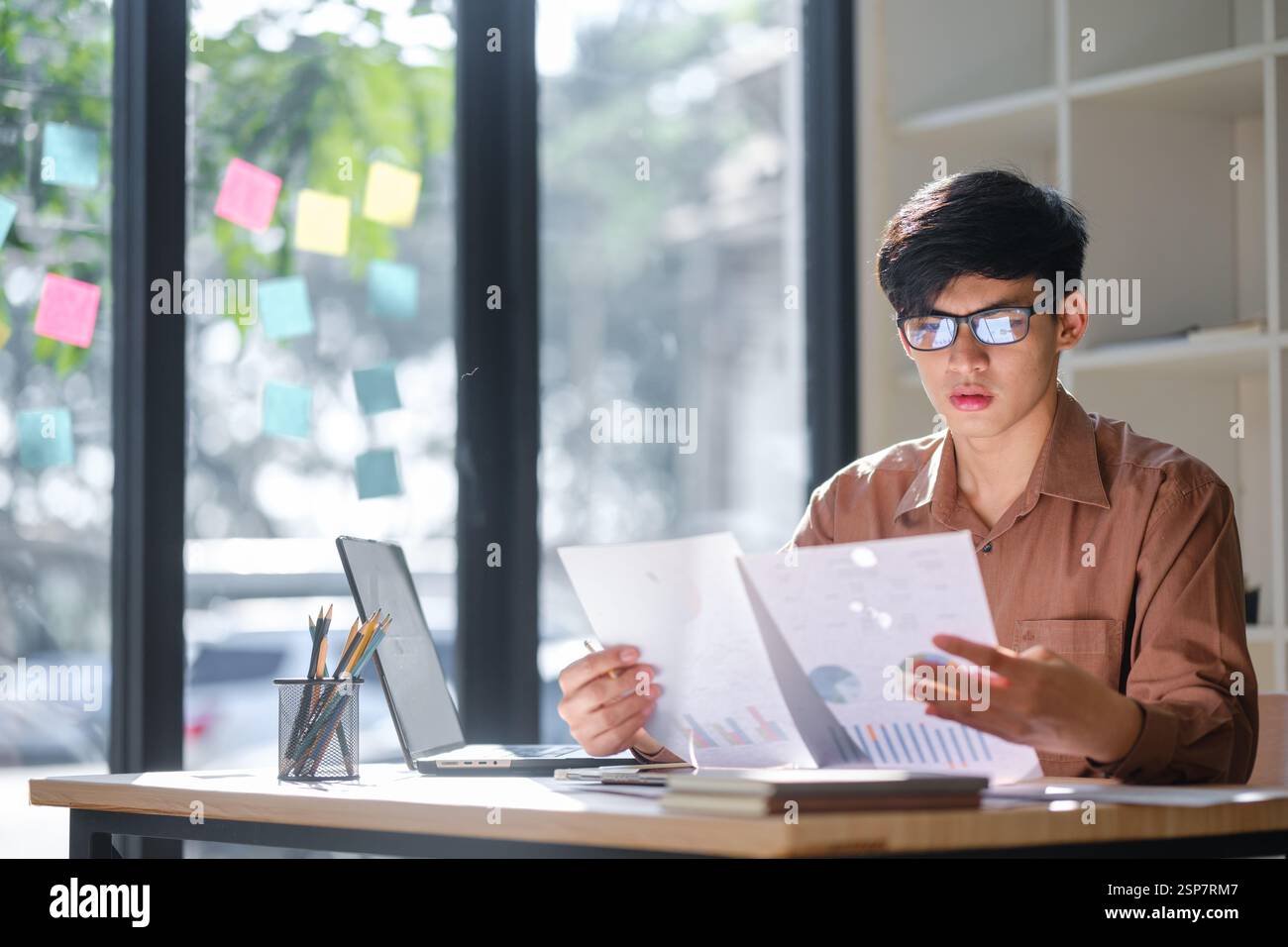 Businessman or student studying online, analyzing financial reports Stock Photo