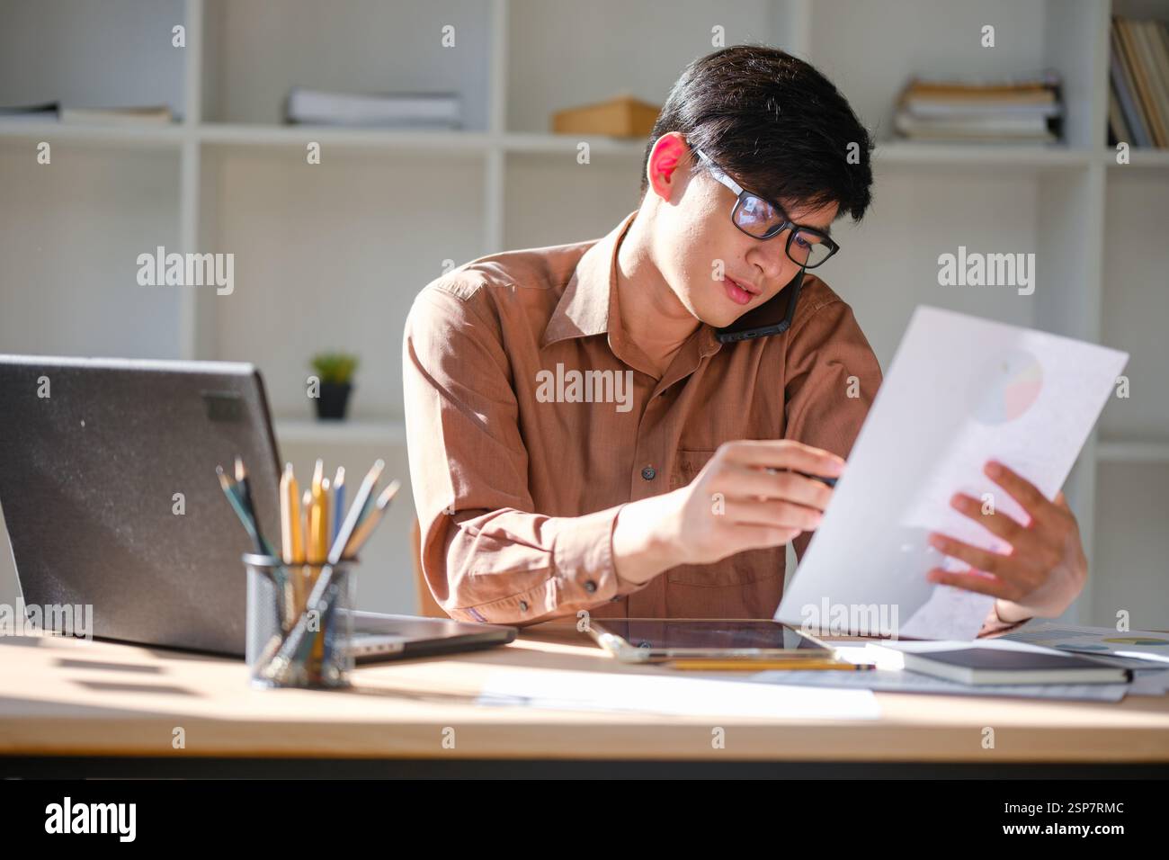 Businessman or student studying online, analyzing financial reports Stock Photo