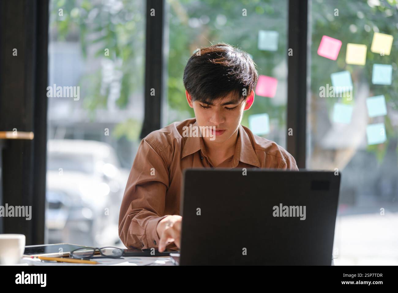 Businessman or student studying online, analyzing financial reports Stock Photo