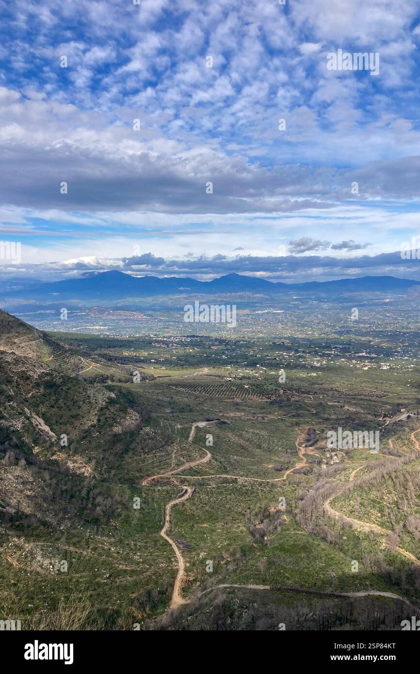 Hiking on trail along abandoned open-pit mine and burnt trees near Mijas, Spain - Smartphone Captured Stock Image
