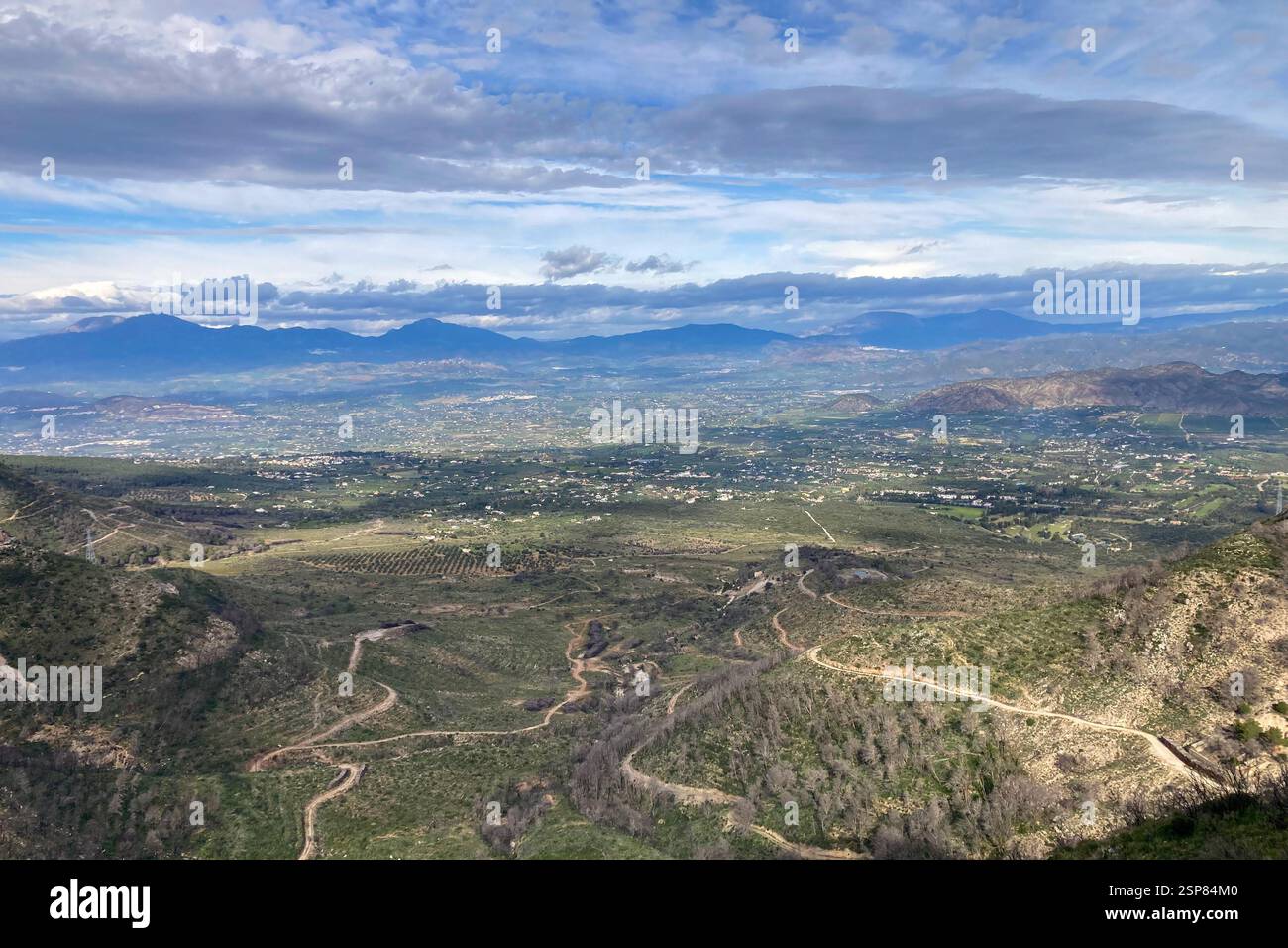 Hiking on trail along abandoned open-pit mine and burnt trees near Mijas, Spain - Smartphone Captured Stock Image