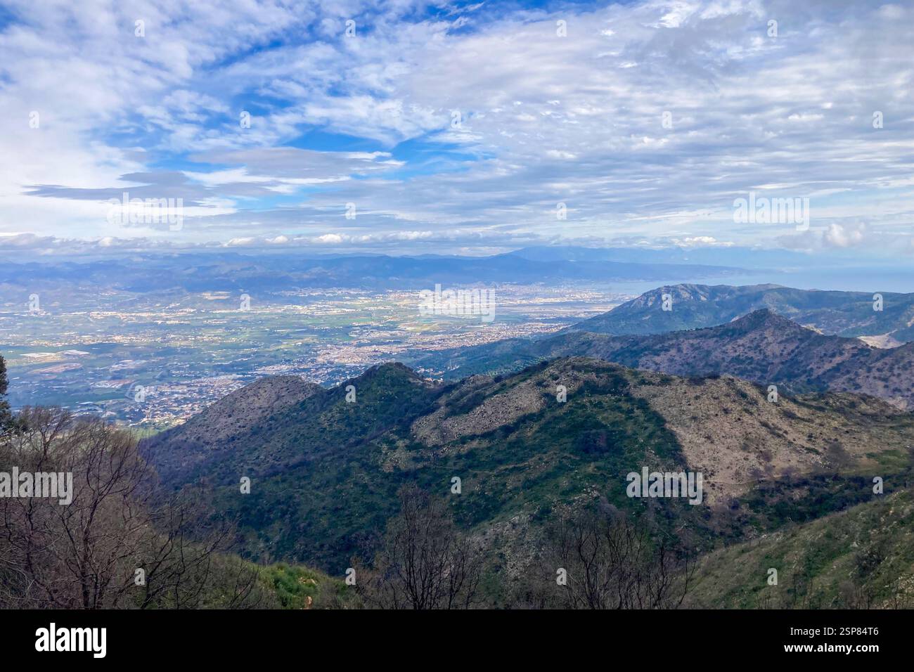 Hiking on trail along abandoned open-pit mine and burnt trees near Mijas, Spain - Smartphone Captured Stock Image