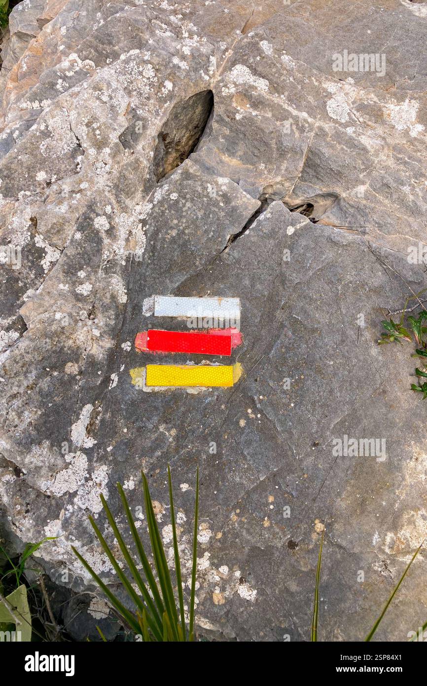 Hiking on trail along abandoned open-pit mine and burnt trees near Mijas, Spain - Smartphone Captured Stock Image