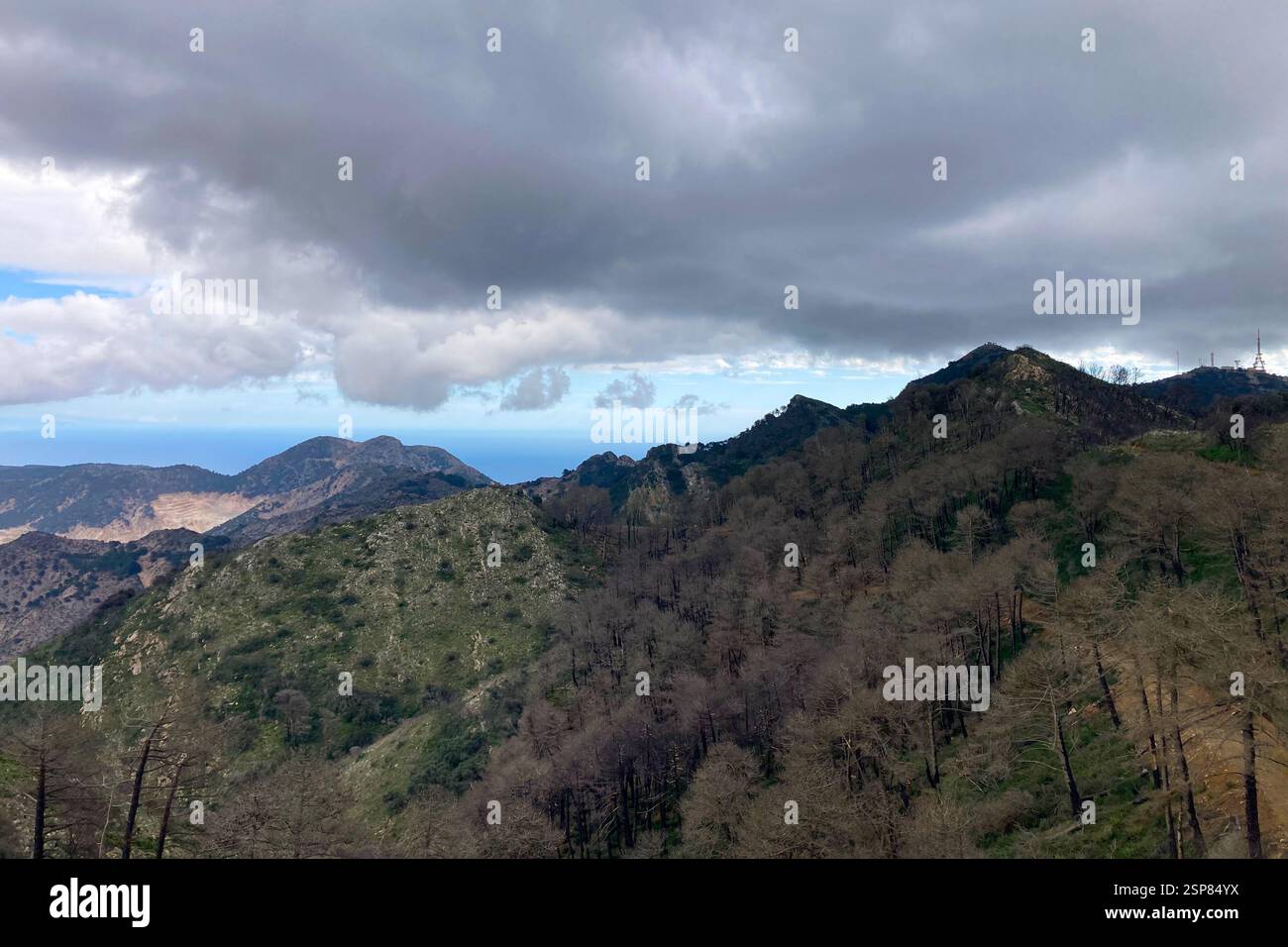 Hiking on trail along abandoned open-pit mine and burnt trees near Mijas, Spain - Smartphone Captured Stock Image