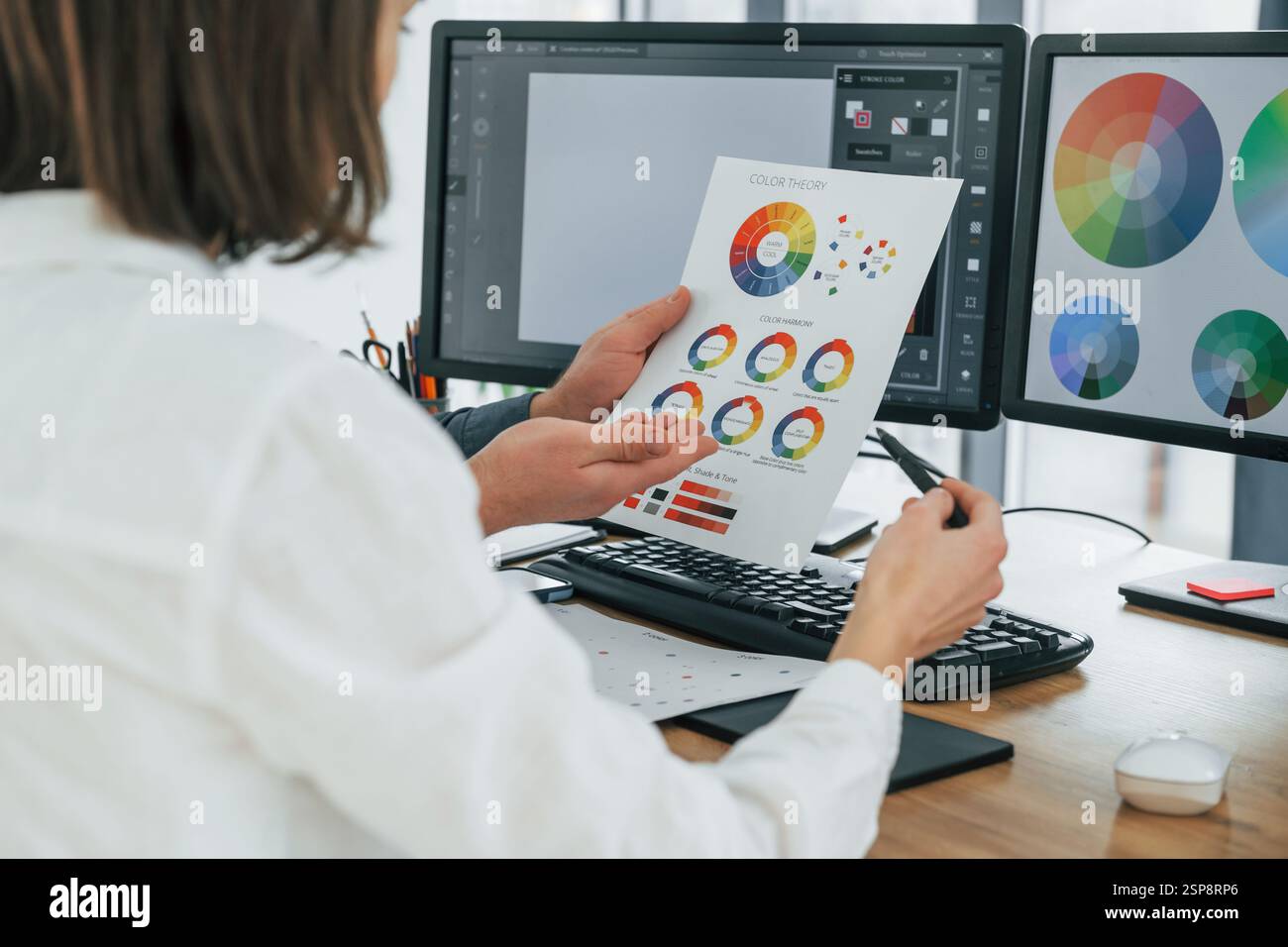Working With Color Choosing right colors. Two designers working together in the office ...