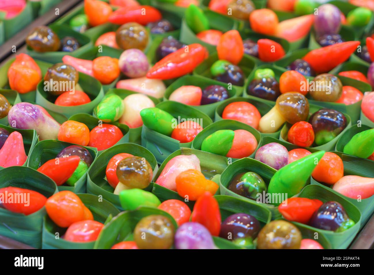 close-up shot of Luk Chup, traditional Thai sweets made from sweetened mung bean paste, skillfully sculpted and painted to resemble miniature fruits a Stock Photo
