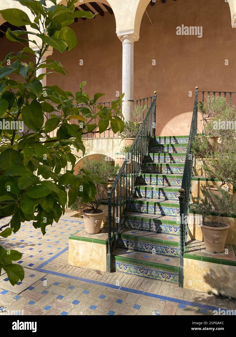 Sunlit serenity in the Alcázar of Seville - where Moorish architecture, intricate tilework, and lush greenery create a timeless oasis. - Smartphone Captured Stock Image