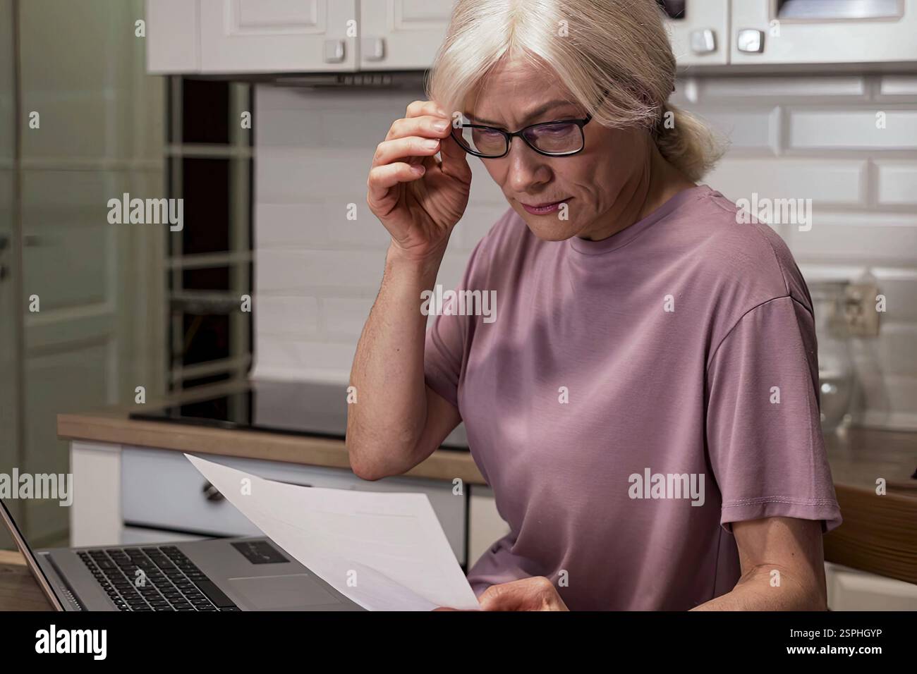 A woman analyses bills and manages the budget Stock Photo
