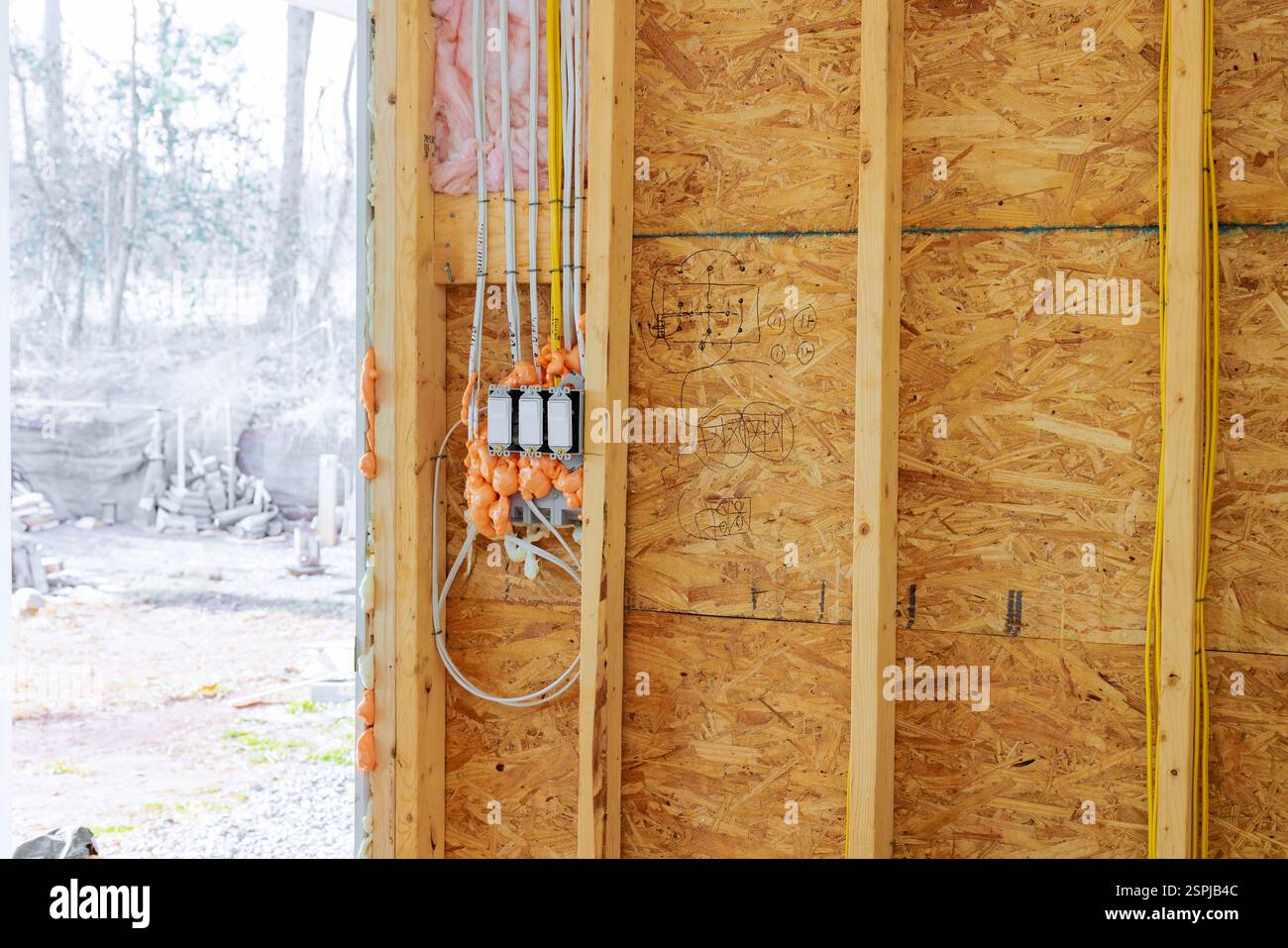 Partially constructed wall displays electrical wiring insulation in ...