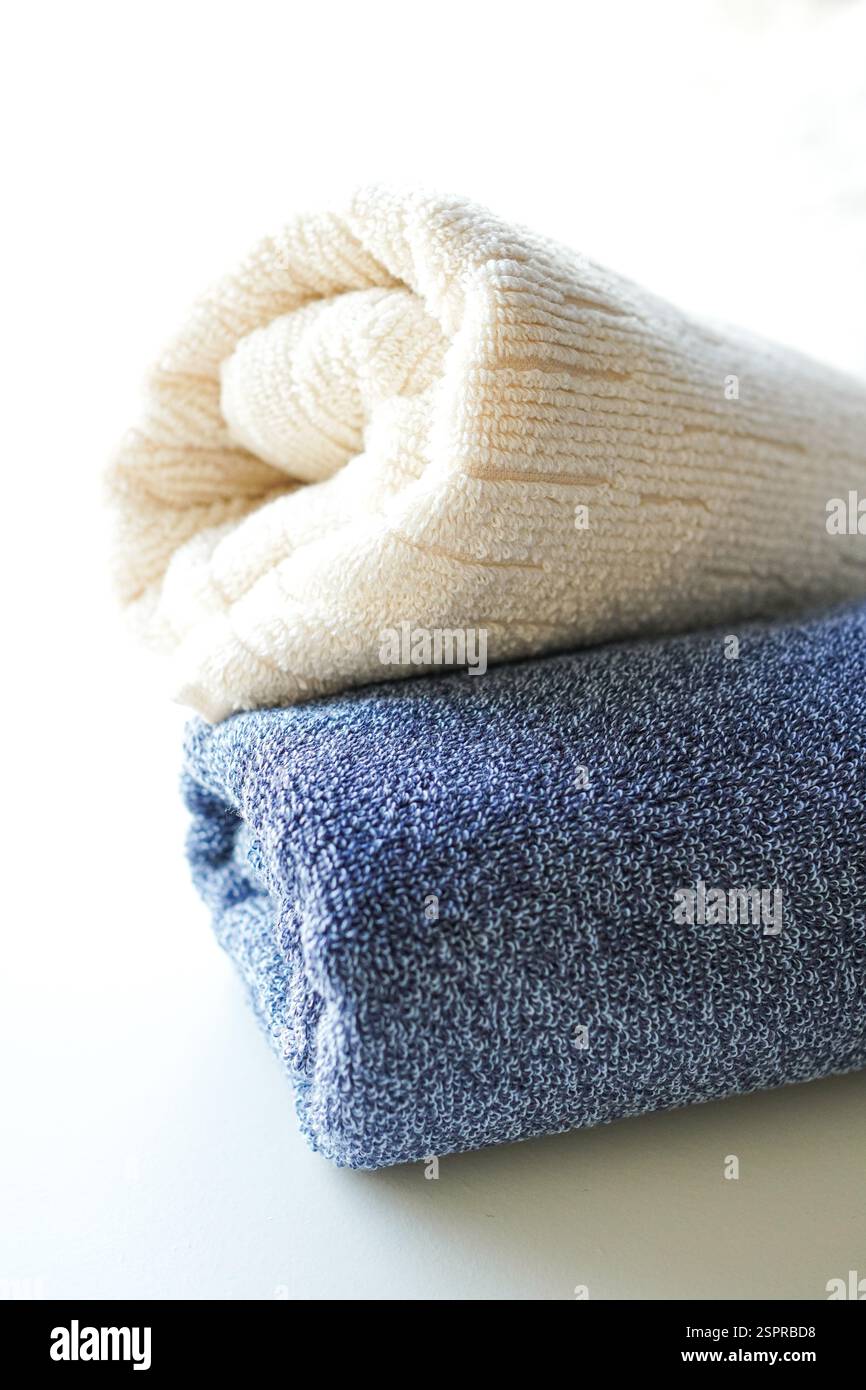 A stack of fluffy towels on white background Stock Photo