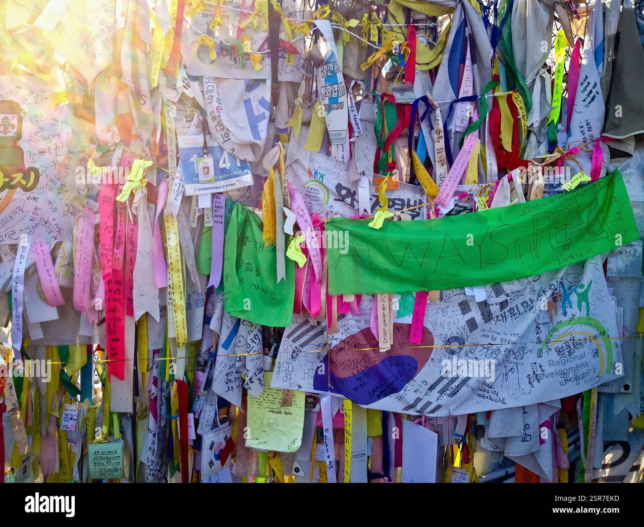 Colorful ribbons and banners tied to a fence with messages of hope and ...