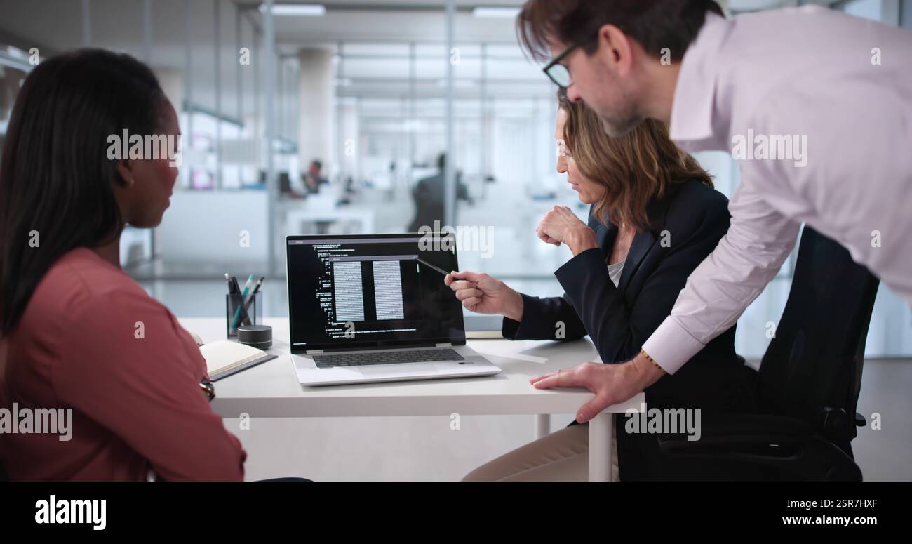 Professional African-American Programmer Leading Diverse Web Development Team in Office Stock Photo