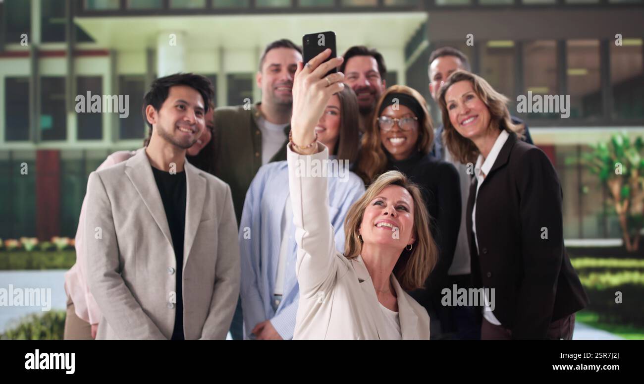 Multicultural Business Team Celebrating Success with Group Selfie at Event Stock Photo