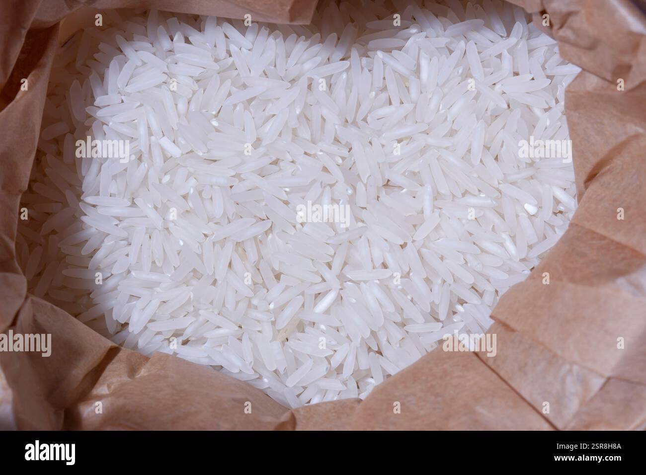 Recycled Rice Raw basmati rice grains in a brown paper bag background. Recycling ...