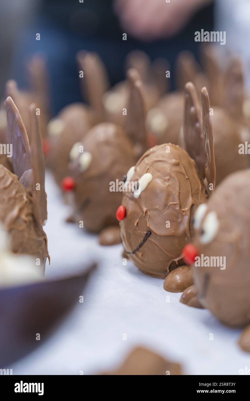 Chocolate delicacies moulded like bunnies with red and white details ...