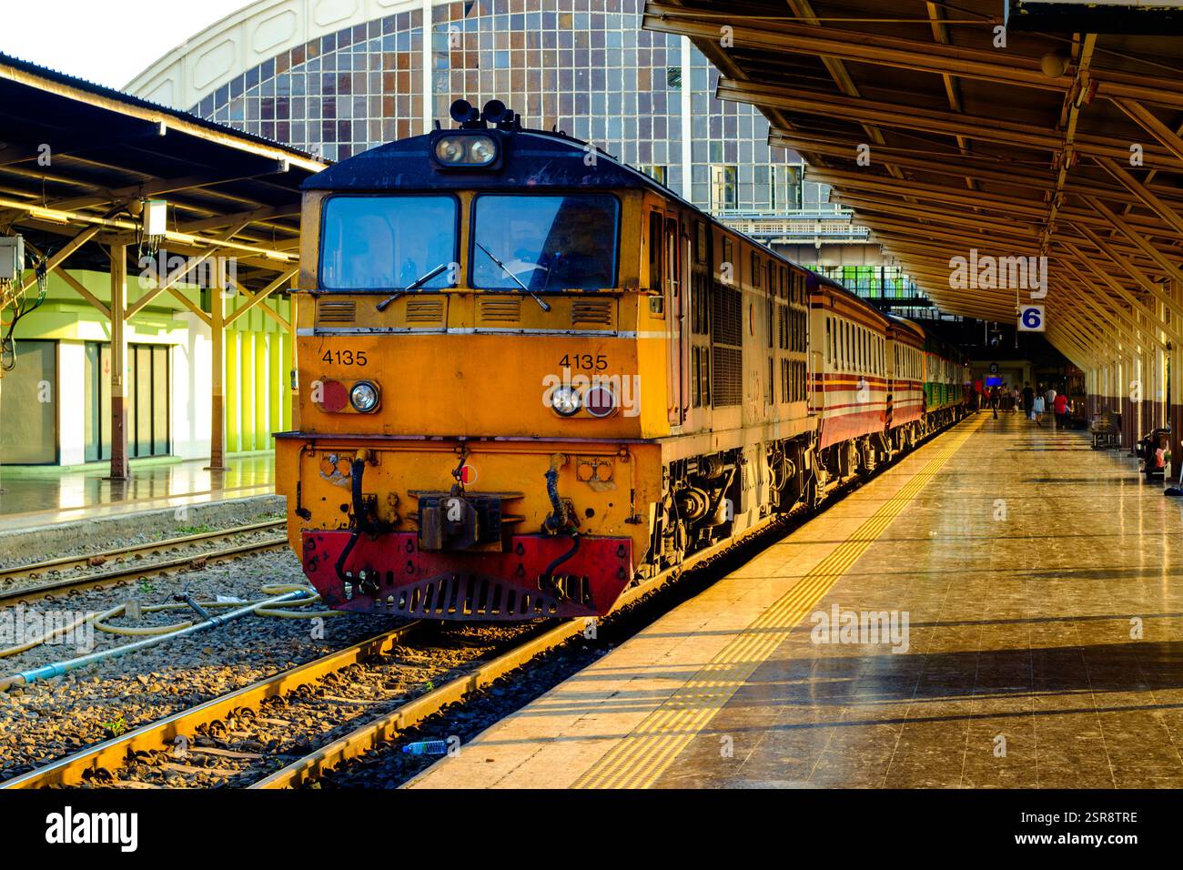 Train Yellow Ramp A striking yellow train stands at a railway station platform ...