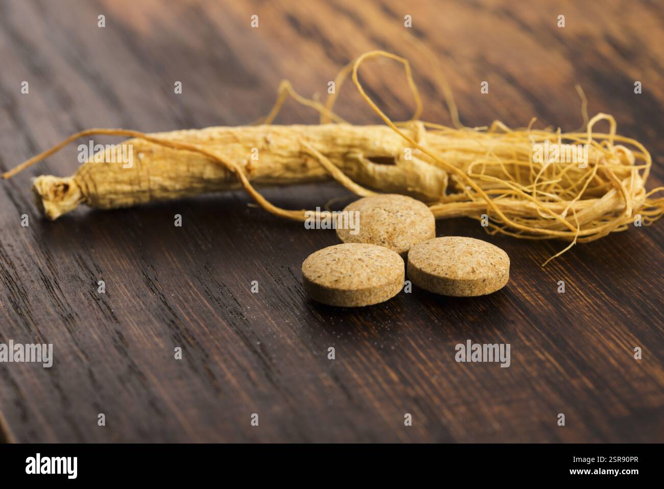 Pill The Roots Korean ginseng. Root and pills Stock Photo - Alamy