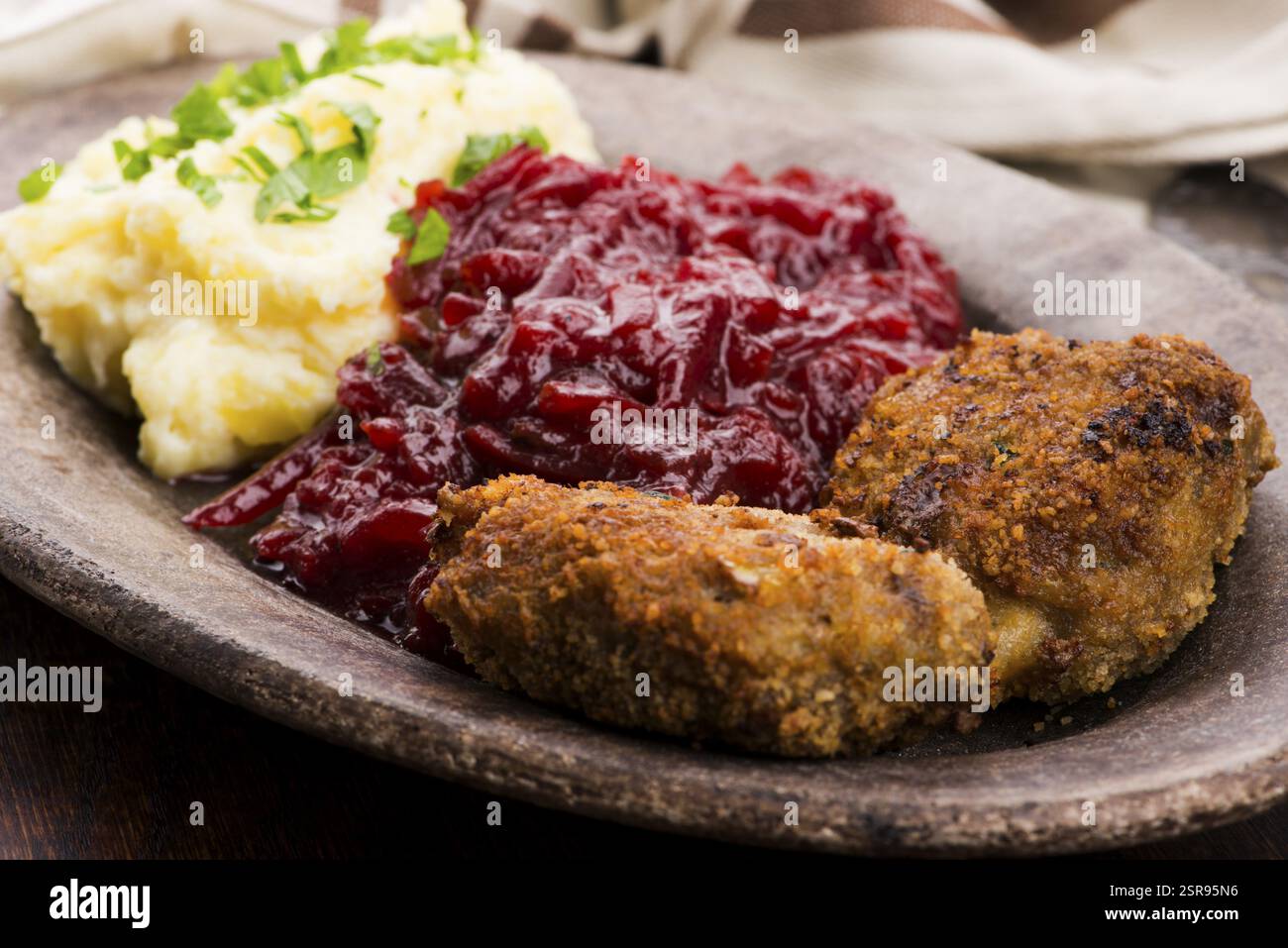 Prepared dinner on the plate. Melted meat, potatoes, beetroot Stock Photo