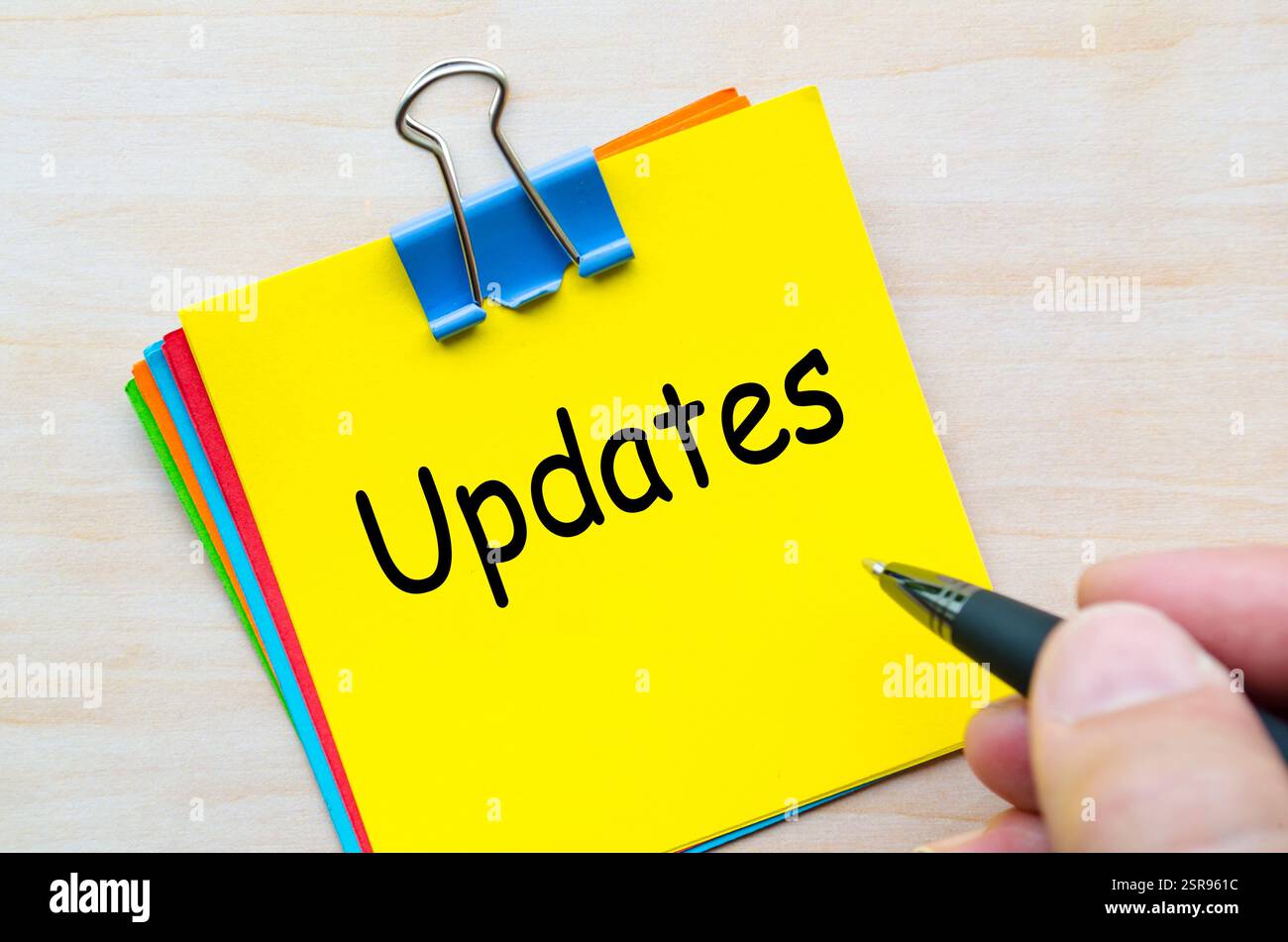 Updates text on yellow sticking notes. Business update concept Stock ...